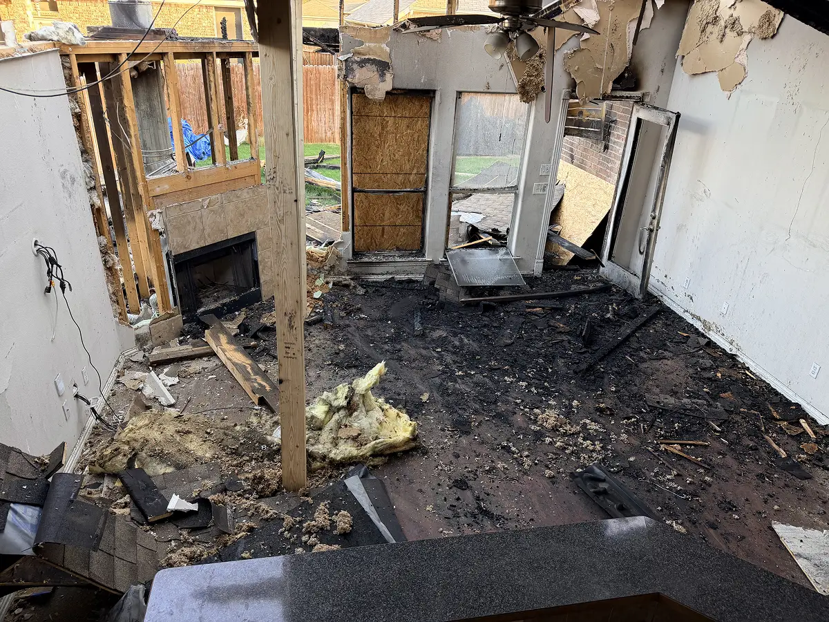 Structural damage repair and framing reconstruction inside a fire-damaged home.