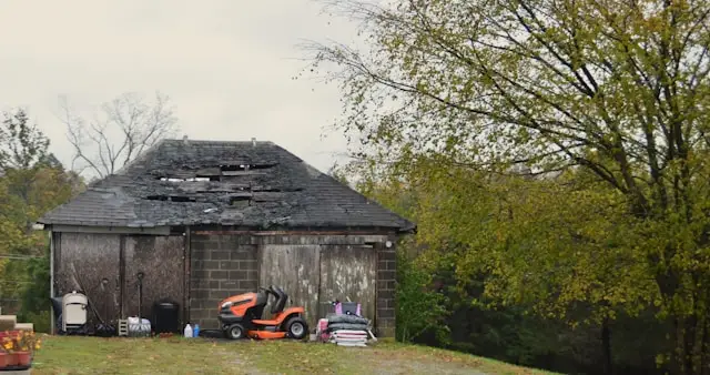 Property with visible roof damage, a reminder to avoid DIY shortcuts after a fire.