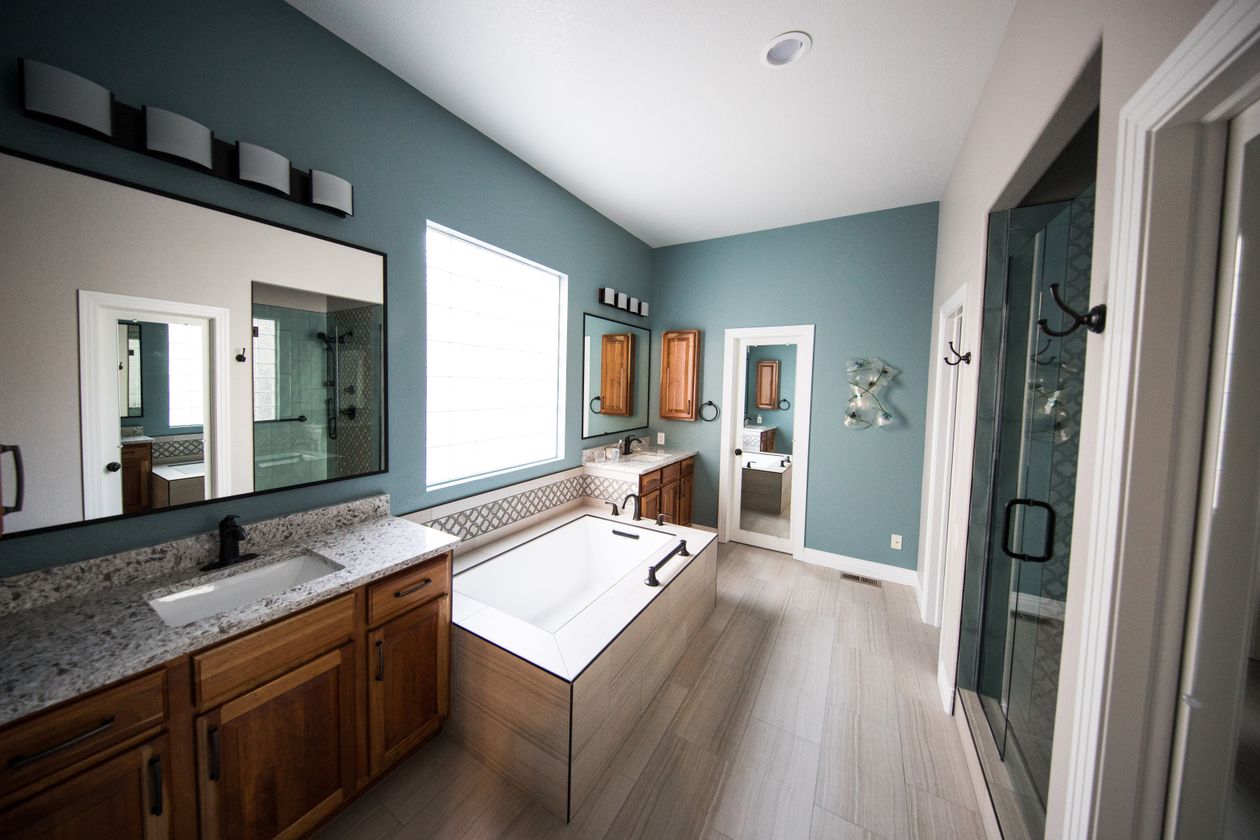 Roomy contemporary bathroom with a freestanding tub and wood cabinets