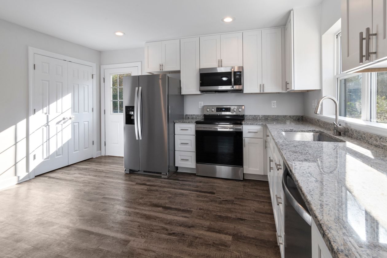 Bright modern kitchen with stainless steel appliances and granite countertops